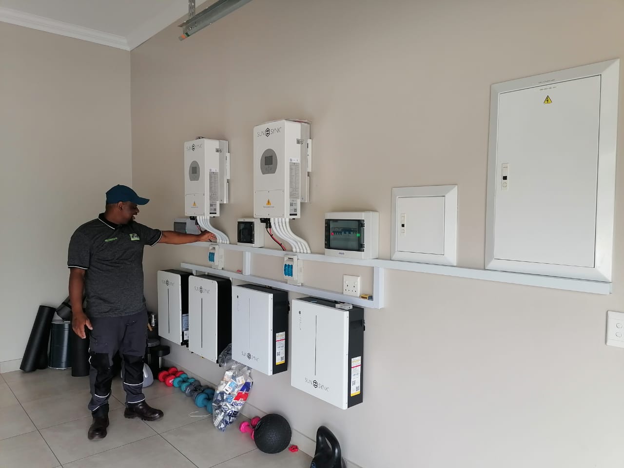 Technician explaining a completed inverter and battery installation