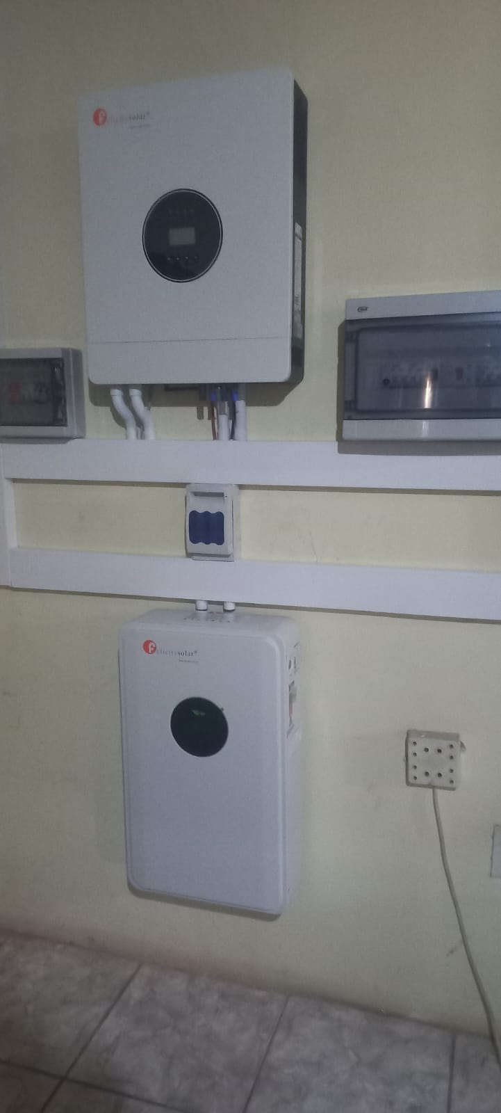 Inverter and battery neatly installed on a wall with distribution boards