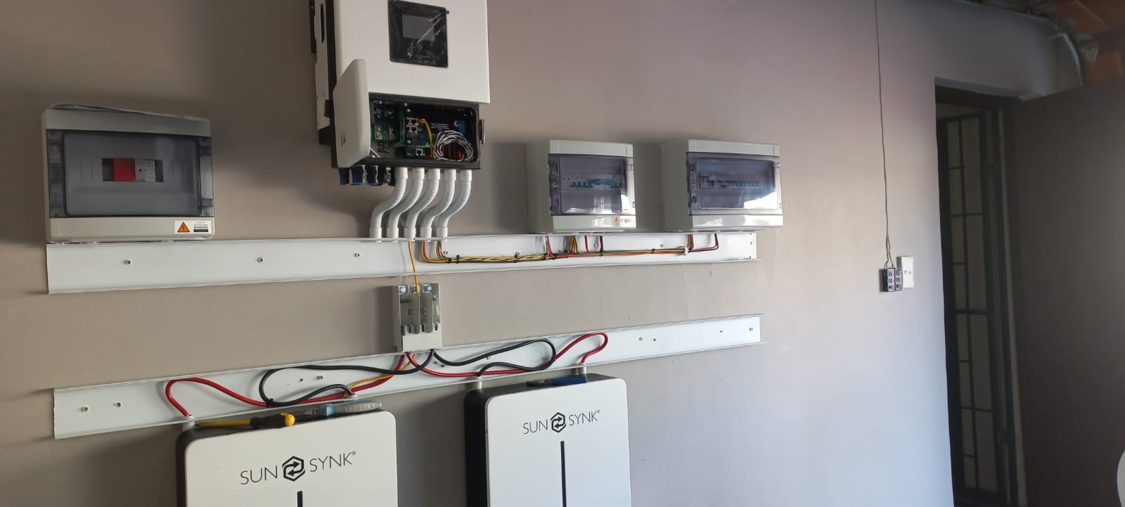Side view of a Sunsynk inverter and battery installation during commissioning